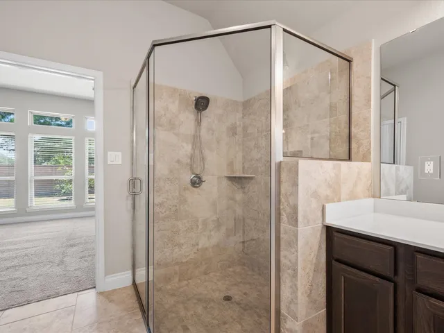 a bathroom with a shower and a sink