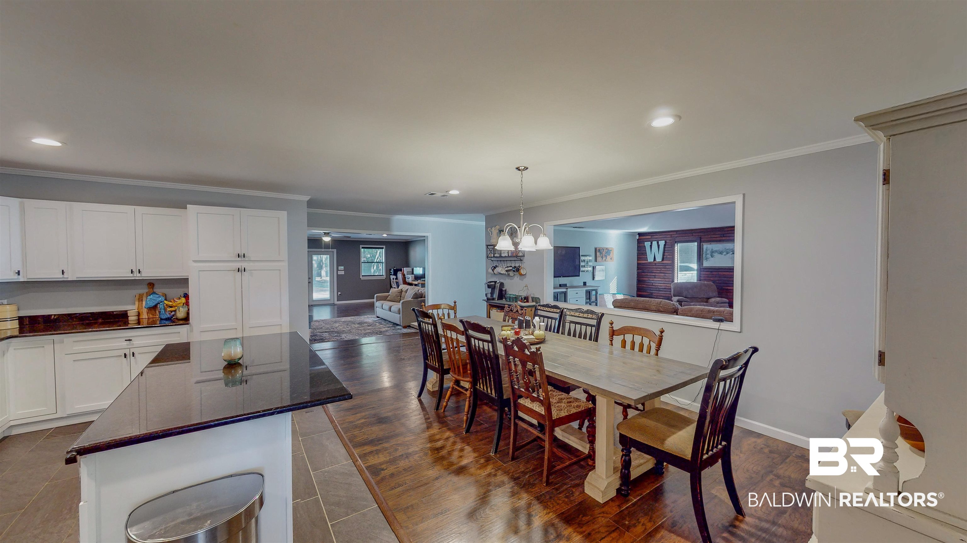 19365 Keller Road Foley, AL 36535 - Photo 7 of 41 Dining space featuring dark hardwood / wood-style floors, crown molding, and a chandelier