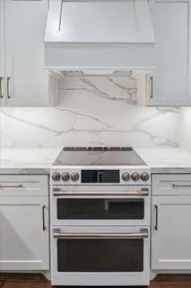 a stove top oven sitting inside of a kitchen