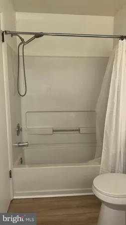 a bathroom with a shower and a toilet
