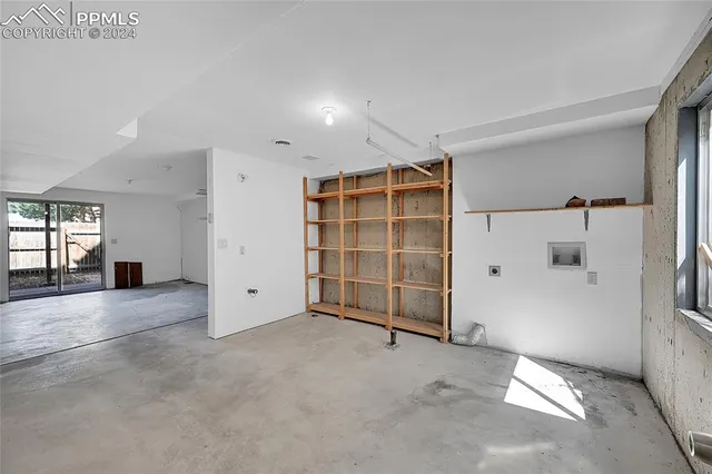 an empty room with a cabinet and mirrors