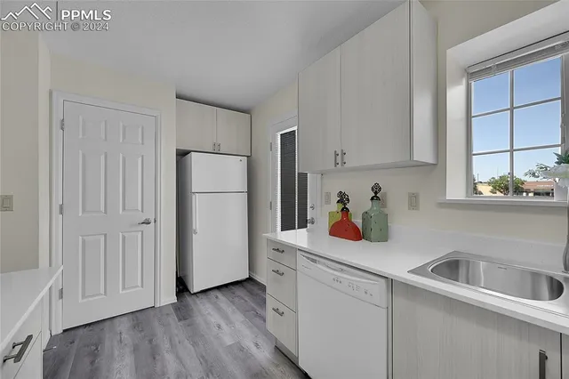 a kitchen with stainless steel appliances a refrigerator sink and cabinets