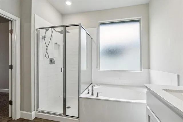 a bathroom with a tub a sink and a shower