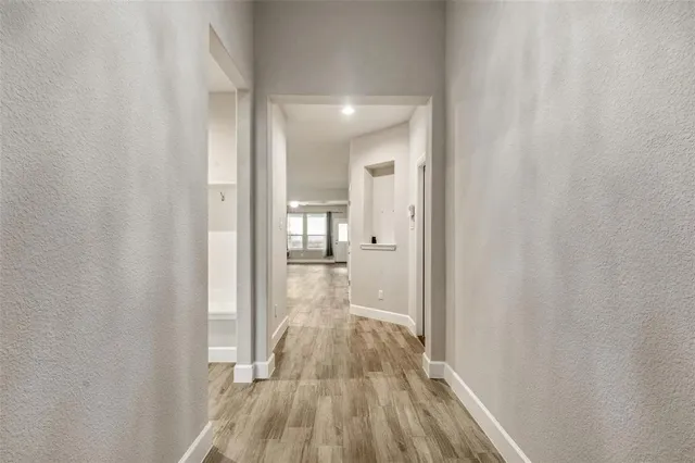 a view of a room with wooden floor