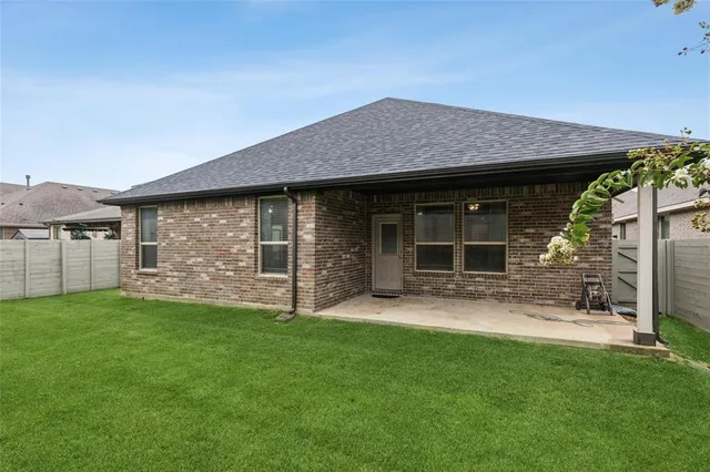 a view of a house with a yard and pathway