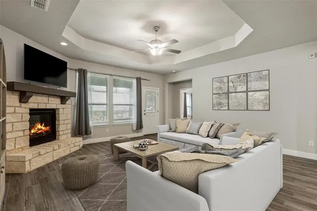 a living room with furniture a flat screen tv and a fireplace