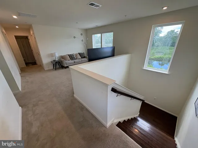a view of a livingroom with furniture and a window