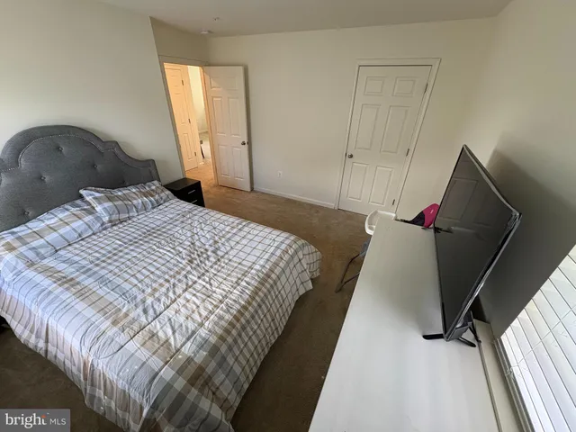 a bedroom with a bed and a mirror