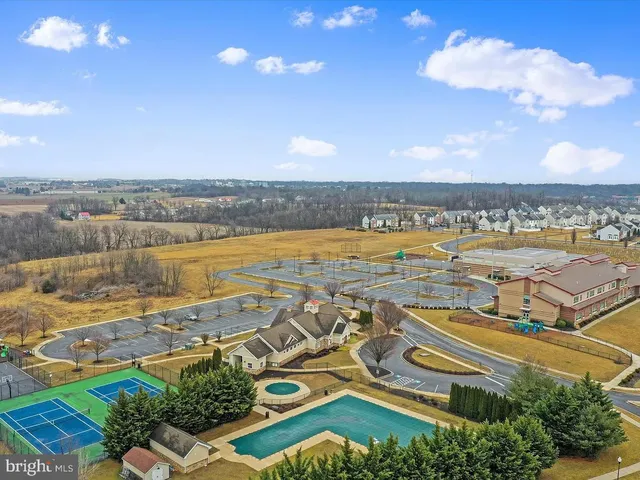 an aerial view of residential building with outdoor space and ocean view