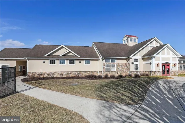 a view of front of house with a wrought fence