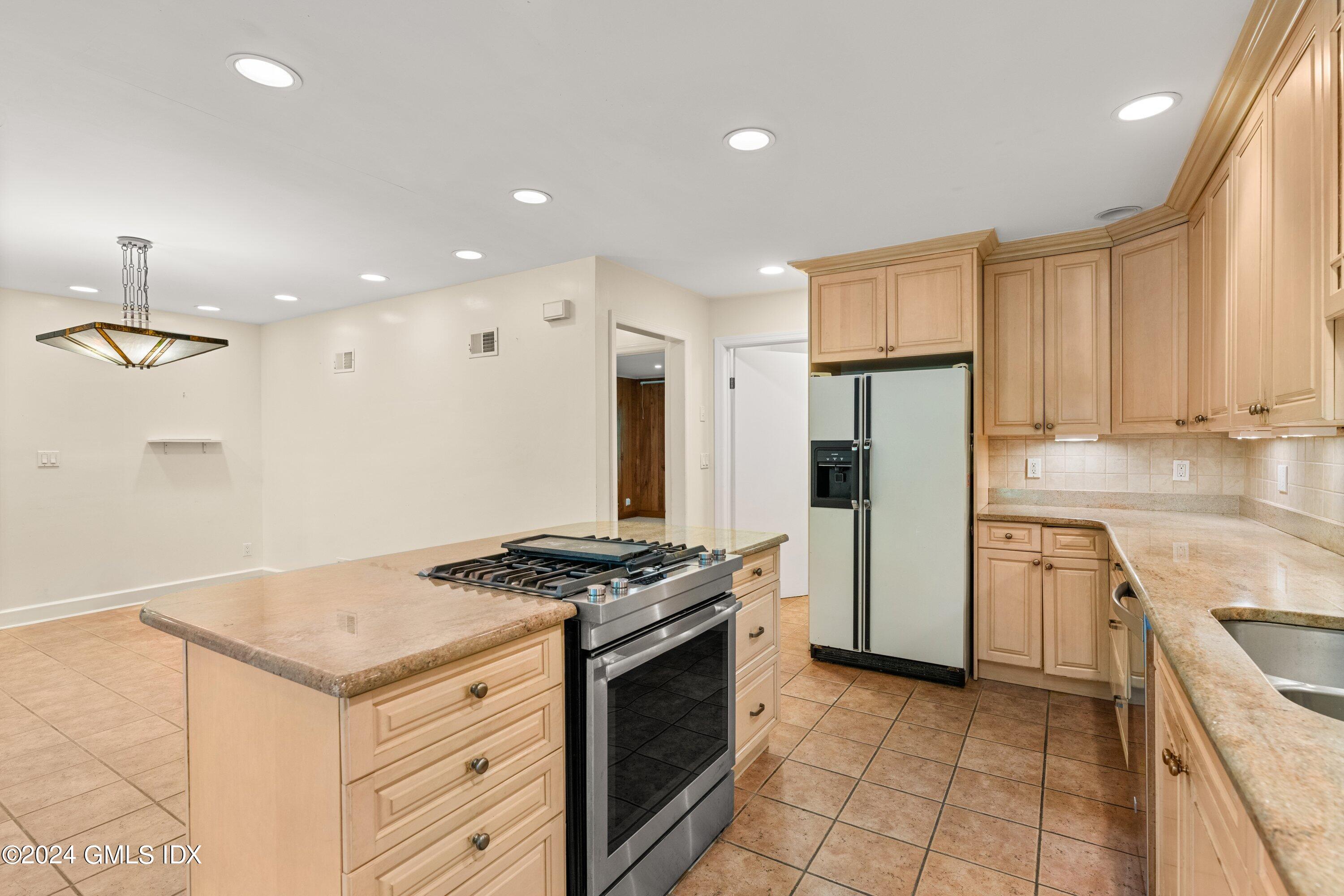 403 Stanwich Road Greenwich, CT 06830 - Photo 9 of 18 a kitchen with a stove a sink and a refrigerator