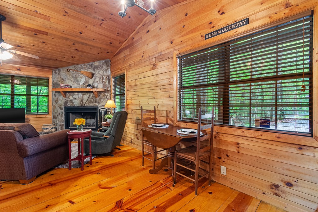67 Tomahawk Trail Blue Ridge, GA 30513 - Photo 17 of 32 a dining room with furniture a fireplace and wooden floor