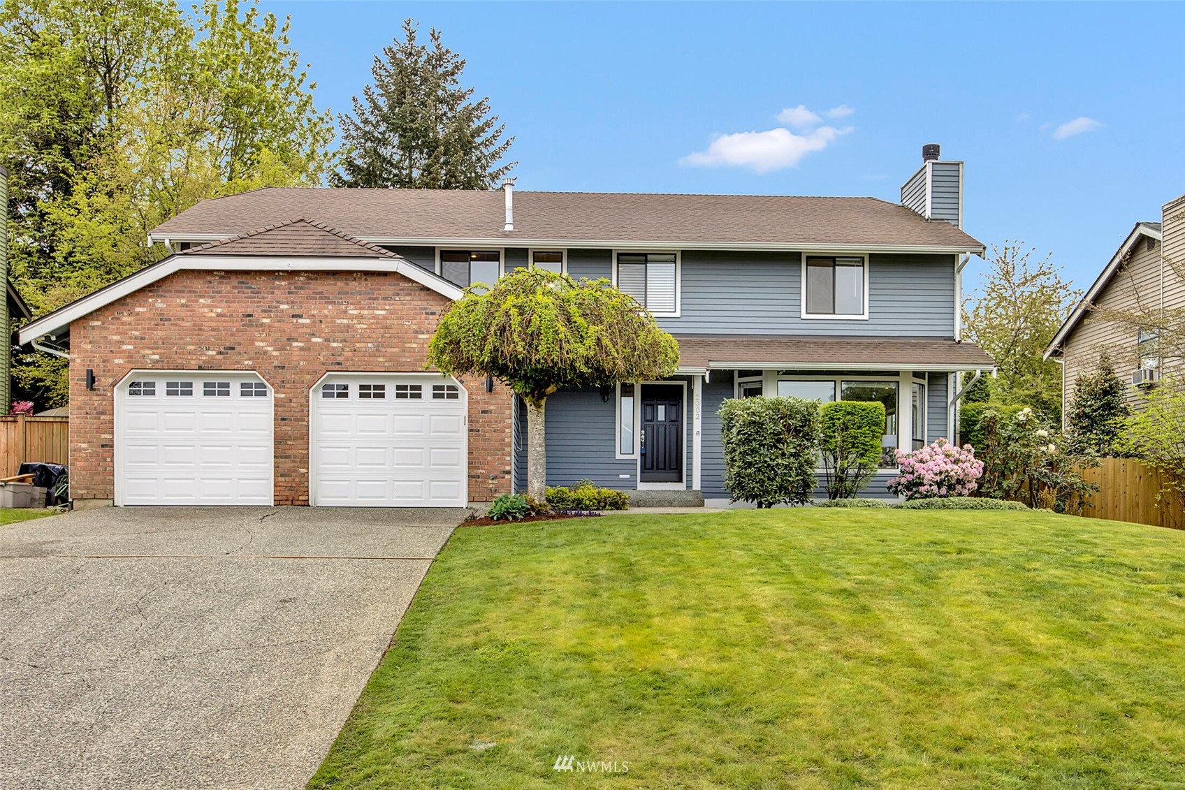 2002 238th Street Southeast Bothell, WA 98021 - Photo 1 of 40 a front view of a house with garden