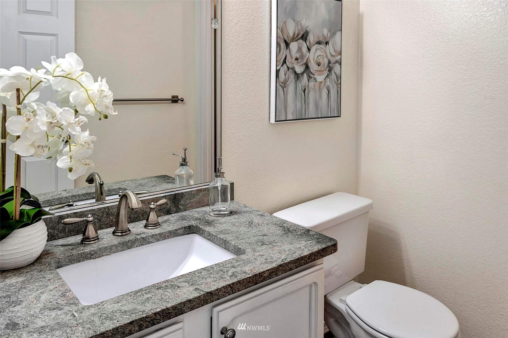 2002 238th Street Southeast Bothell, WA 98021 - Photo 18 of 40 a bathroom with a granite countertop toilet sink and mirror
