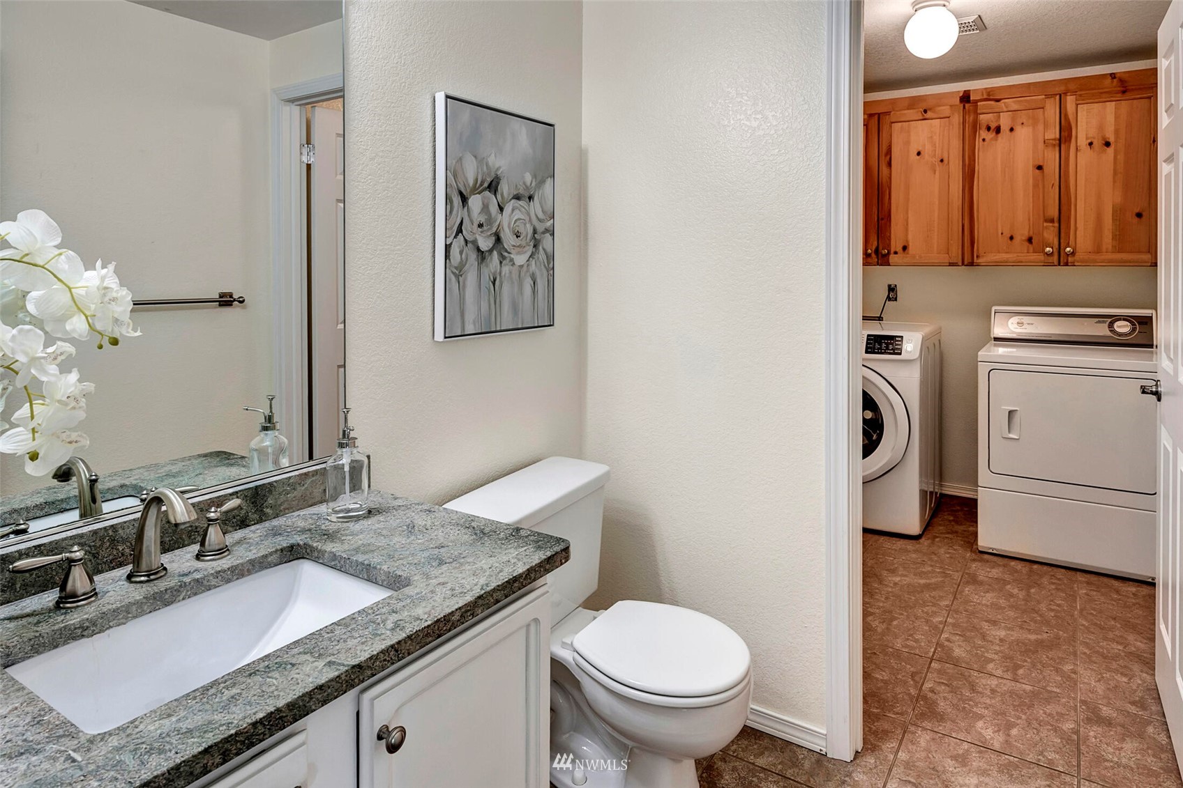 2002 238th Street Southeast Bothell, WA 98021 - Photo 19 of 40 a bathroom with a granite countertop toilet sink and mirror