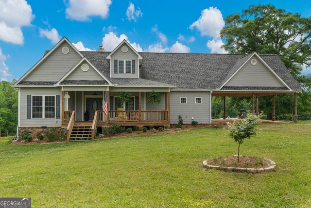 a front view of a house with a garden and porch