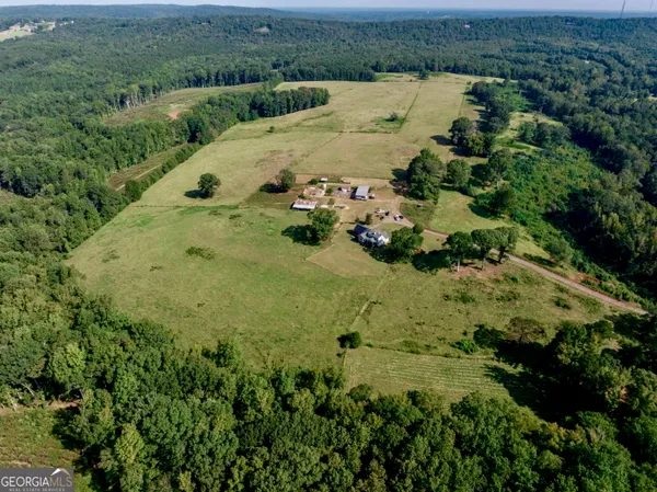an aerial view of a house with garden space lake view and mountain view in back