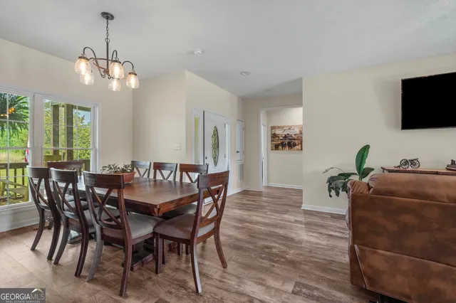 a view of a dining room with furniture and a flat screen tv