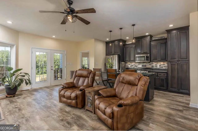 a bedroom with a large bed a lamp and a chandelier