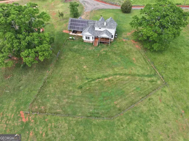 a backyard of a house with a table and chairs