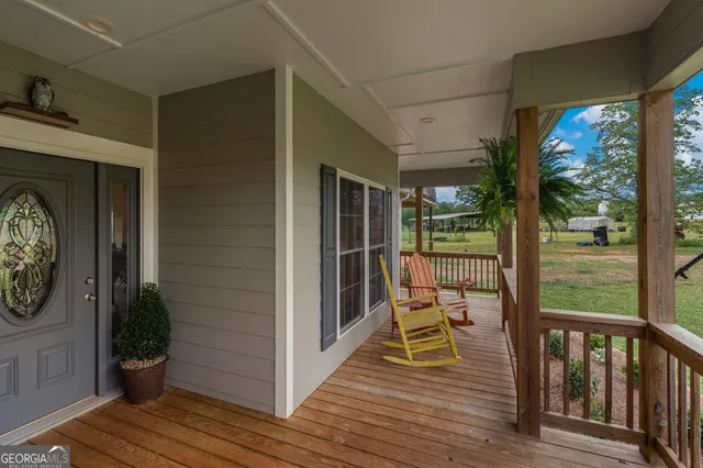 a view of a dining room with furniture a chandelier and wooden floor