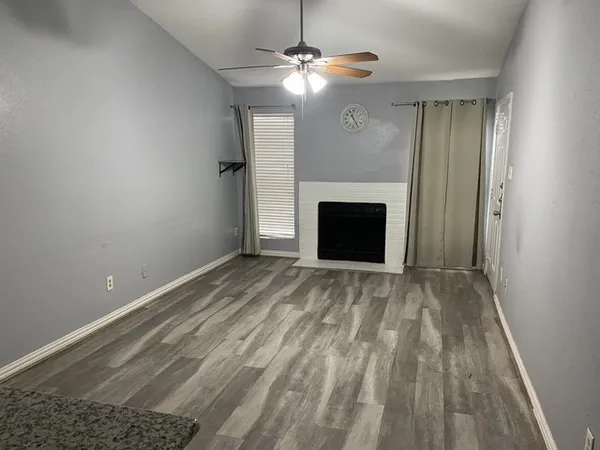 a view of empty room with fireplace