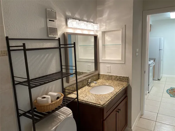a bathroom with a sink vanity and mirror