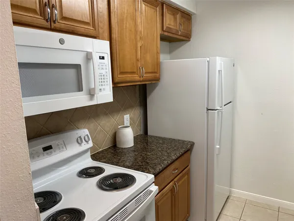 a kitchen with a stove and a refrigerator