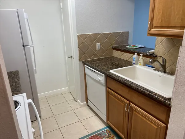 a utility room with sink dryer and washer