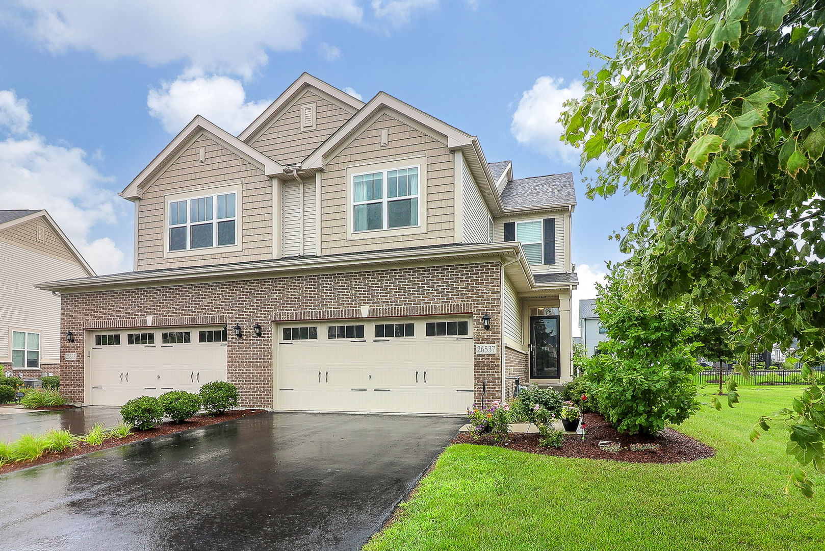 26537 West Countryside Lane Plainfield, IL 60585 - Photo 1 of 19 a front view of a house with a garden and plants