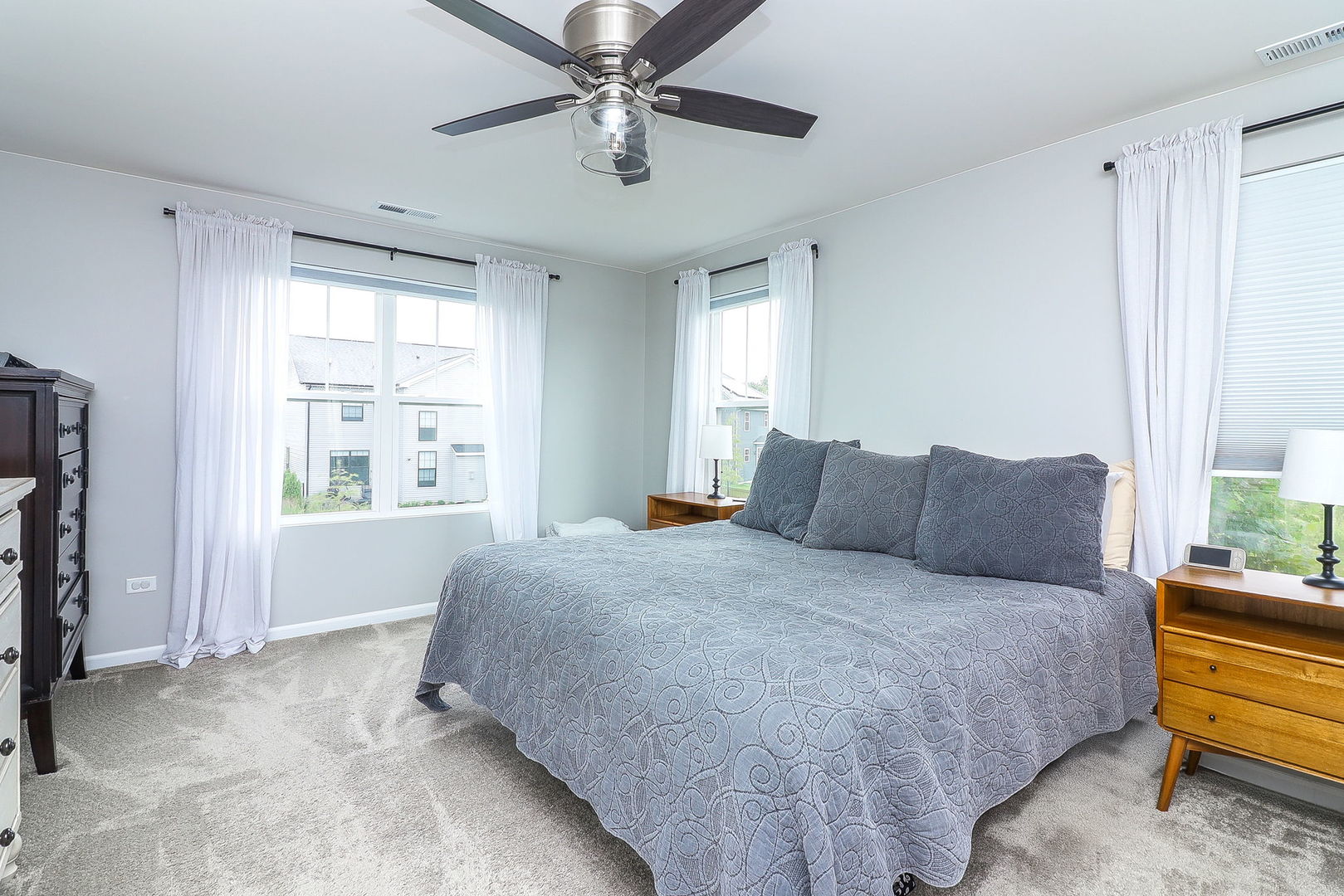 26537 West Countryside Lane Plainfield, IL 60585 - Photo 9 of 19 a spacious bedroom with a large bed and a chandelier