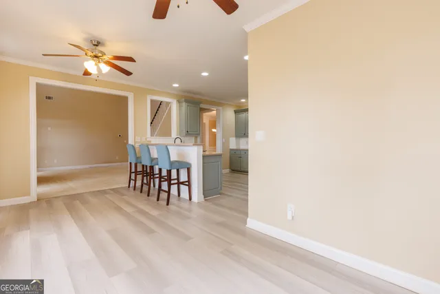 a kitchen with a sink cabinets and wooden floor