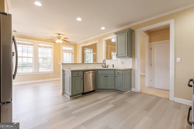 a view of kitchen with furniture and refrigerator