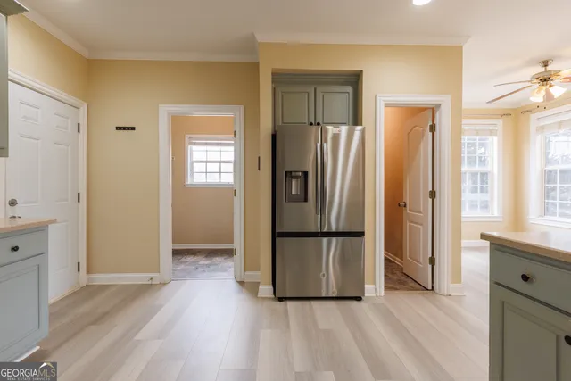 a kitchen with white cabinets and stainless steel appliances