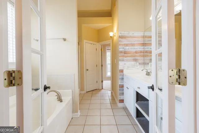 a bathroom with a tub and shower