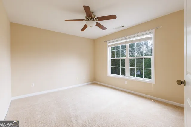 a view of a small space with wooden floor and a bathroom