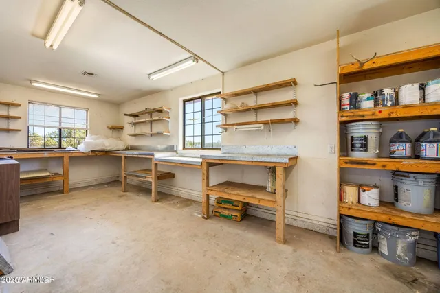 a room with furniture a air conditioner vent and a window