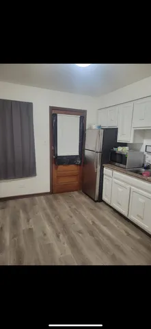 a view of a room with furniture and a lamp