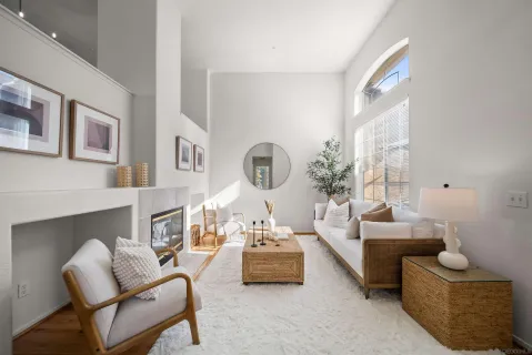 a living room with furniture and a mirror