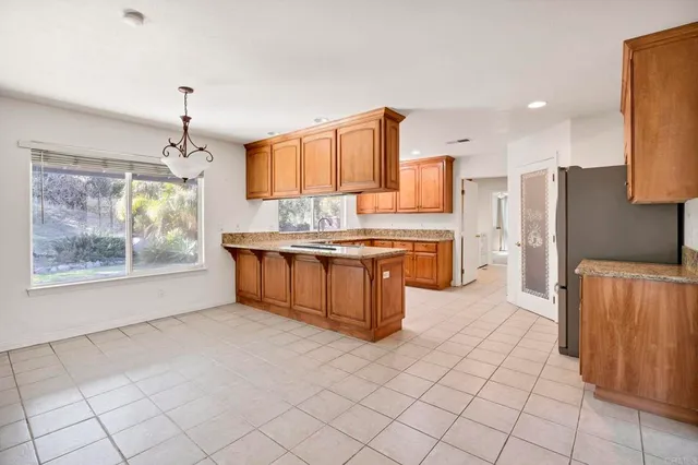 a kitchen with stainless steel appliances a sink and a refrigerator