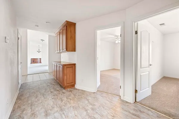 an empty room with windows and closet