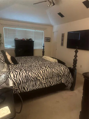 a bedroom with a bed and window