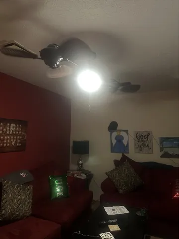 a living room with furniture and a lamp