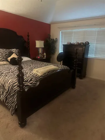a bedroom with a bed and a chair