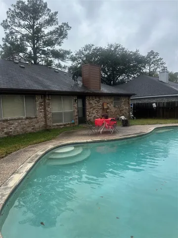 a view of a house with a backyard