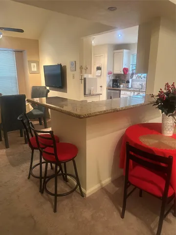 a room with a table chairs and a workspace