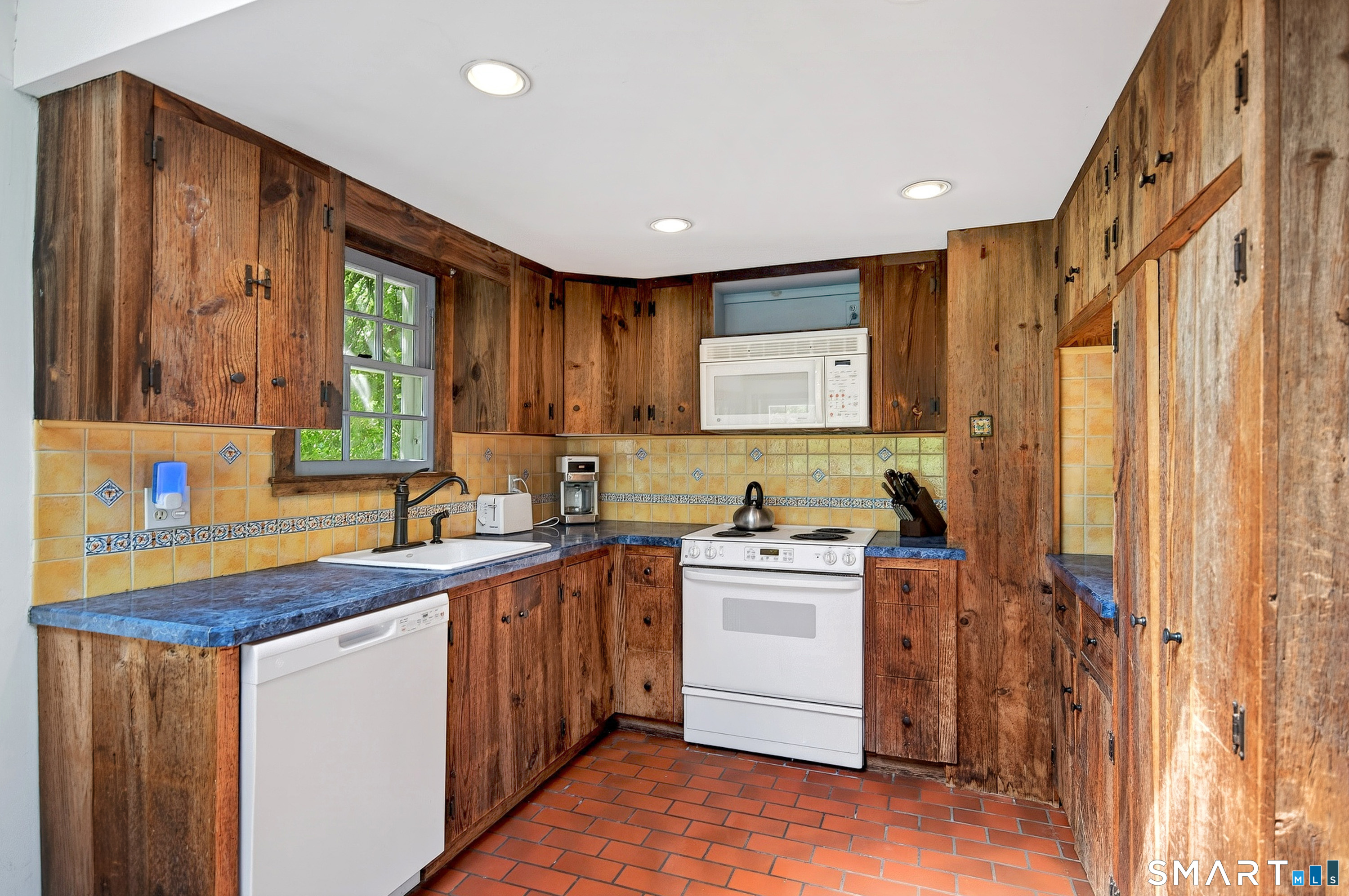 6 High Rock Road Newtown, CT 06482 - Photo 12 of 40 a kitchen with a sink a stove a refrigerator and cabinets