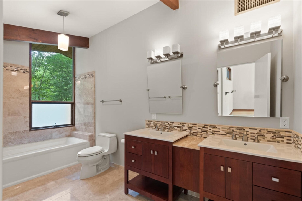 15 Pilgrims Path Sudbury, MA 01776 - Photo 12 of 29 a spacious bathroom with a granite countertop double vanity sink a mirror and a bathtub