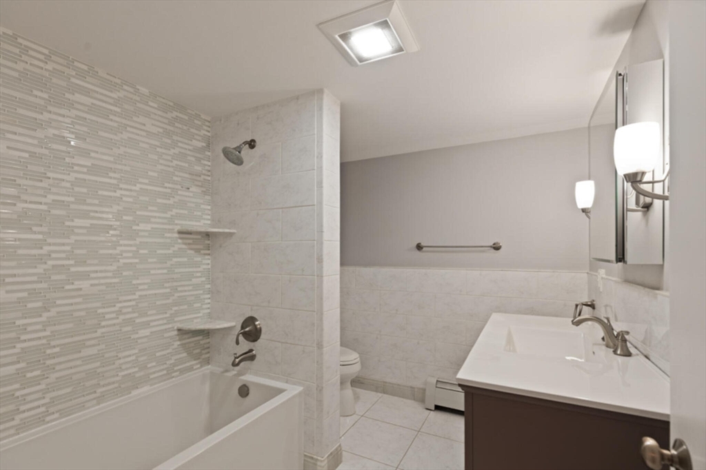 15 Pilgrims Path Sudbury, MA 01776 - Photo 16 of 29 a bathroom with a sink a toilet and bathtub