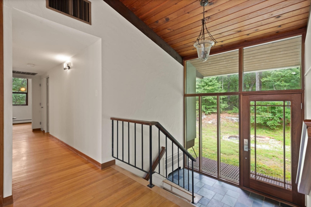 15 Pilgrims Path Sudbury, MA 01776 - Photo 4 of 29 a view of a hallway with wooden floor and stairs
